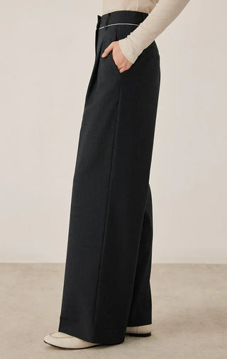 Black wide-leg tailored pants with side pleats, high waist, and long straight drape
