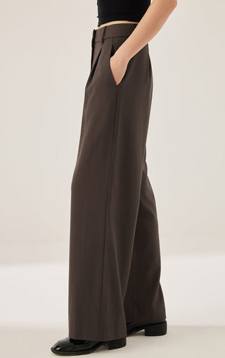 Dark brown wide-leg tailored pants with belt loops and front pleats, side view
