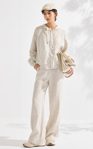 Beige linen wide-leg trousers on model, relaxed fit with wide waistband