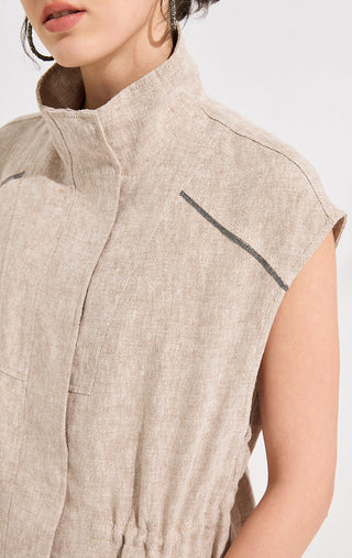 Close-up of camel linen sleeveless vest front with stand collar and contrast black stitching