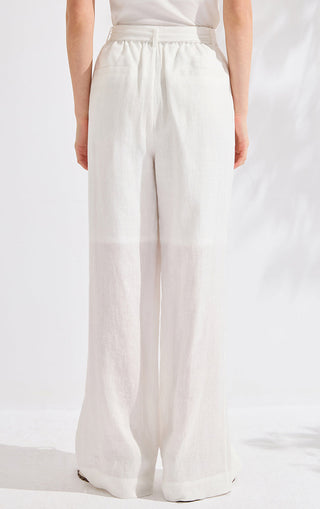 White linen wide-leg pants with elastic waistband and relaxed straight legs