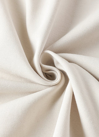 Oatmeal knit fabric close-up with smooth woven texture