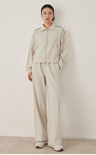 Full-length view of cream relaxed wide-leg pants with elastic waist and drawstring