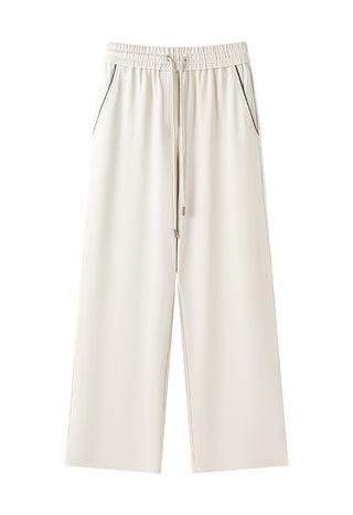 Studio view of cream relaxed wide-leg pants with elastic waistband and drawstring