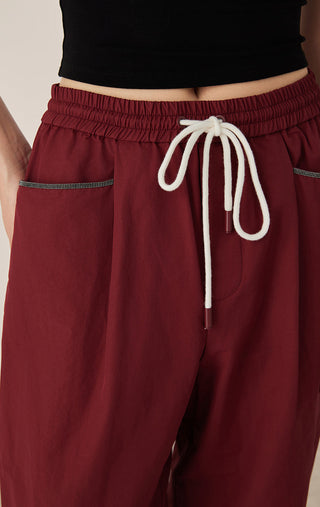 Deep red women’s drawstring waist pants with white rope tie and elastic waistband
