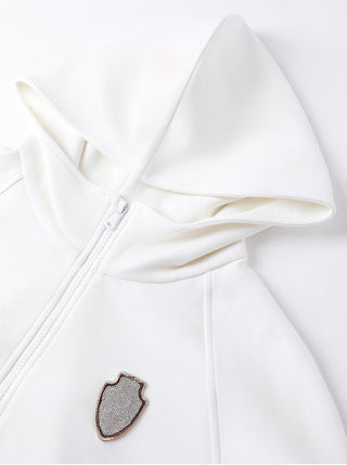 White zip-up hoodie with hood, front zipper, and shield crest badge