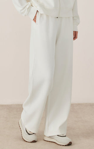 White wide-leg lounge pants with elastic waist and relaxed cuffed hem
