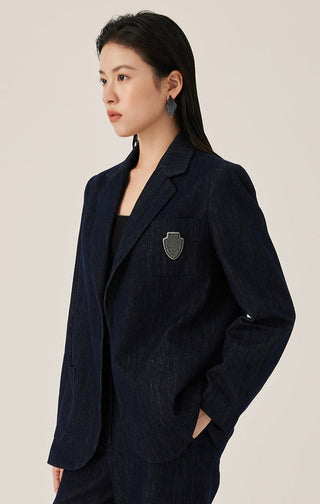 Dark blue blazer with crest emblem patch, notched lapel, and flap pocket detail