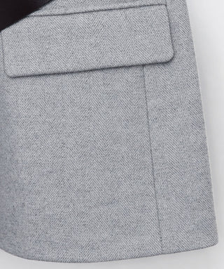 Grey herringbone-textured vest skirt with flap pocket detail
