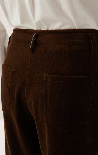 Corduroy wide-leg pants close-up: dark brown front pocket and zipper