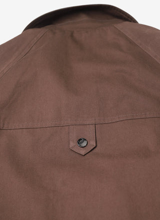 Brown stand-collar jacket back with small triangular patch and stitched yoke seam