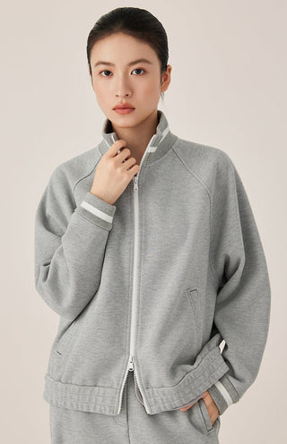Gray blue zip-up track jacket with stand collar, striped cuffs, and front kangaroo pocket