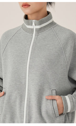 Gray blue zip-up track jacket close-up with white zipper and kangaroo pocket