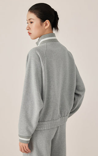 Gray blue zip-up track jacket back view with ribbed hem and striped collar detail