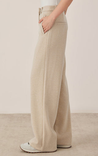 Khaki/beige wide-leg pants with clean seam lines, side pockets, and ankle-length drape.