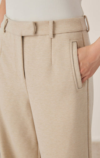 Khaki/beige pants close-up: fitted waistband, belt loops, and front side pocket.