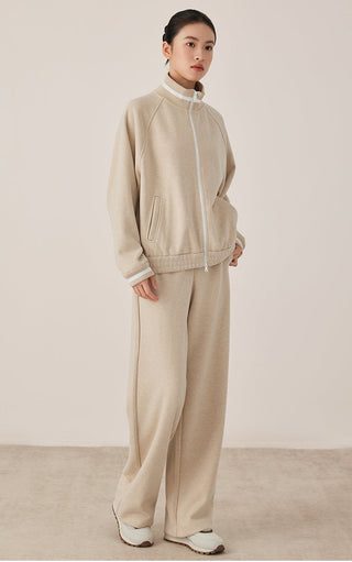 Khaki/beige wide-leg pants on model with elastic waistband look and side pocket details.