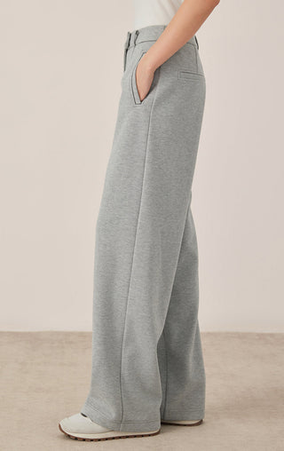 Gray-blue wide-leg pants side view with front pocket flap and roomy leg opening.