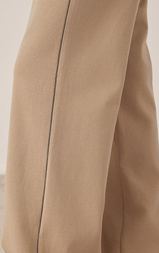 Khaki wide-leg pants close-up of side seam and smooth fabric texture