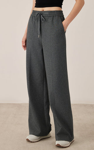 Dark gray wide-leg pants with tied drawstring at elastic waist and roomy legs