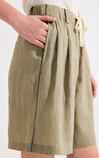 Army green linen shorts close-up: drawstring waist and side silver beaded chain detail