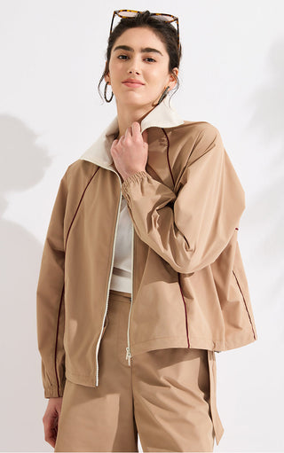 Khaki zip-up track jacket with off-white collar, dark red piping and roomy sleeves