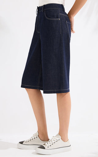 Denim blue denim shorts with front pleat, patch pockets, and waistband button