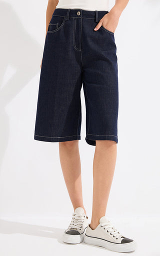 Denim blue denim shorts, side view with contrast topstitching and wide cuff hem