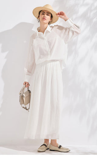 White long-sleeve button shirt with airy fabric, pointed collar, and draped sleeves