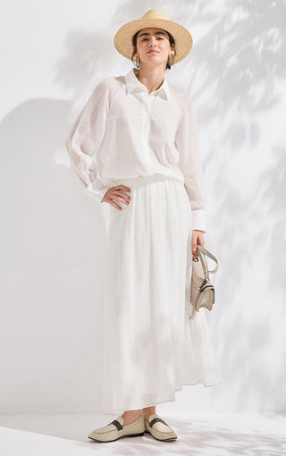 White long-sleeve button shirt with loose fit, collared neckline, and beaded cuffs