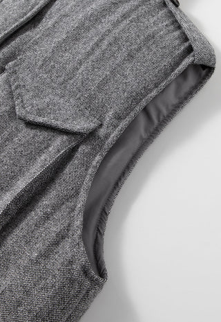 Grey wool-blend utility down vest close-up: stand collar, zip seam, textured fabric
