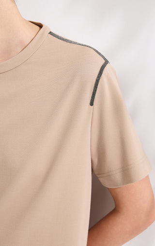 Camel t-shirt close-up of shoulder seam with contrast black trim