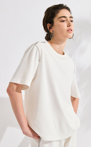 White T-shirt with silver beaded trim on shoulder seam; short sleeves