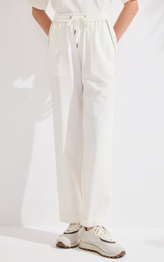 Ivory white wide-leg cotton-blend pants with elastic waist and drawstring, patch pockets