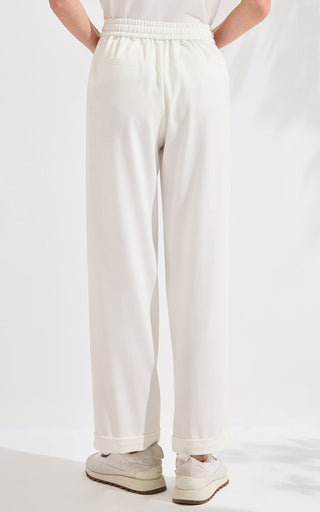 Ivory white wide-leg pants with elastic waist and back patch pockets