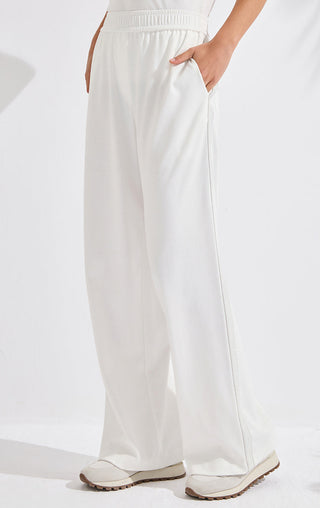 White loose wide-leg cotton pants with front pockets and pull-on waist