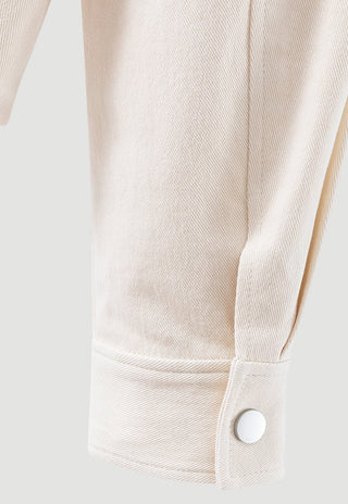 Beige cotton zip-up jacket cuff with snap and stitched hem detail.