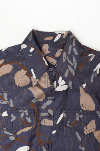 Navy printed dress chest with turn-down collar and dark buttons, long sleeves.