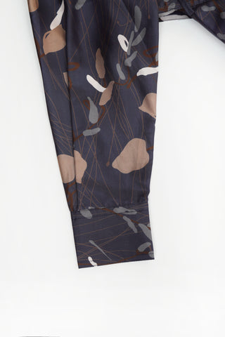 Navy printed dress hem section with flowing skirt panel and soft drape.