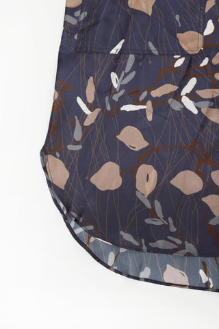 Navy printed dress skirt with button placket detail and curved hem edge.