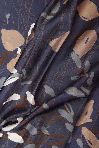 Navy printed silk-like fabric with abstract leaf motifs and fine line details.