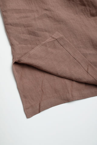 Brown linen dress hem with stitched seam and side panel detail