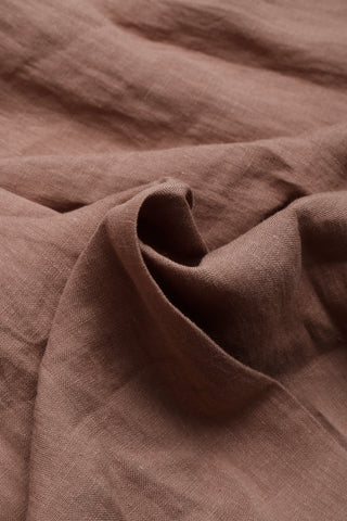 Close-up of brown linen fabric texture with soft drape