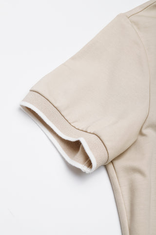 Camel polo dress sleeve cuff with ribbed trim and white contrast edging.