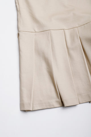 Camel cotton polo pleated dress, pleated skirt detail and hem seam close-up