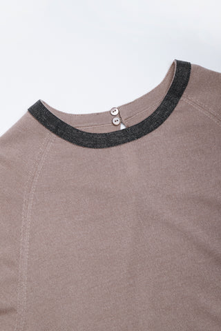 Neckline close-up: taupe knit dress with dark beaded collar trim and two buttons
