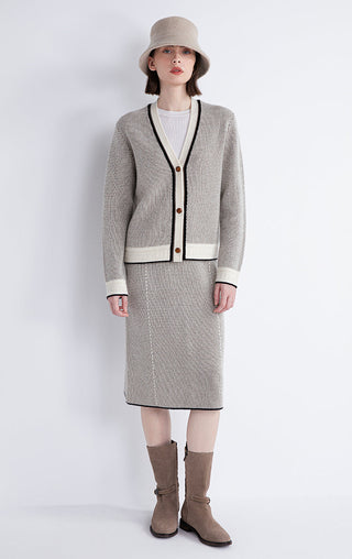 Gray wool-cashmere cardigan with black trim and brown buttons, full-length model view