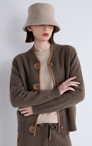 Dark camel cardigan front detail: contrast-trim placket, round buttons, ribbed sleeves