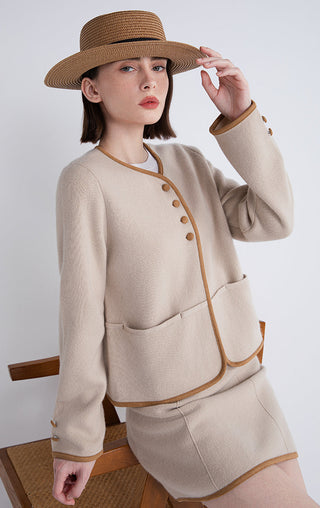 Camel jacket with contrast piping, front buttons, and patch pockets at waist