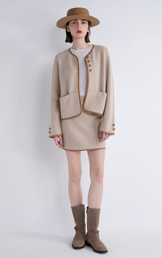 Camel jacket with contrast-trim front, patch pockets, and buttoned cuffs